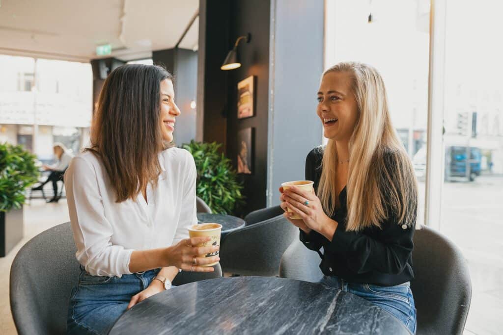 girls in cafe laughing