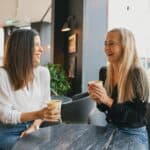 girls in cafe laughing