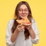 girl eating pizza